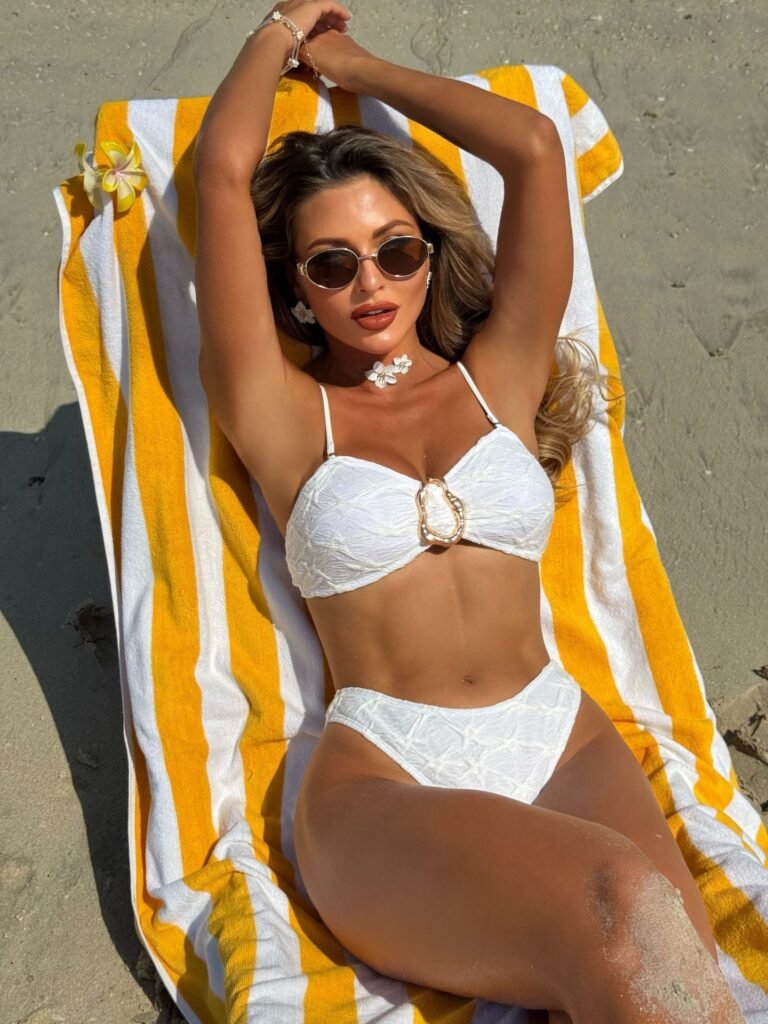 Model Wearing Shell Ring Bikini Set in White – Beach Scene